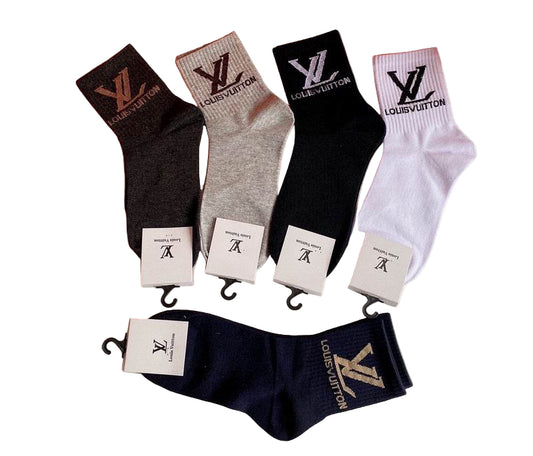 Set of Louis Vuitton socks in various colors with brand labels.