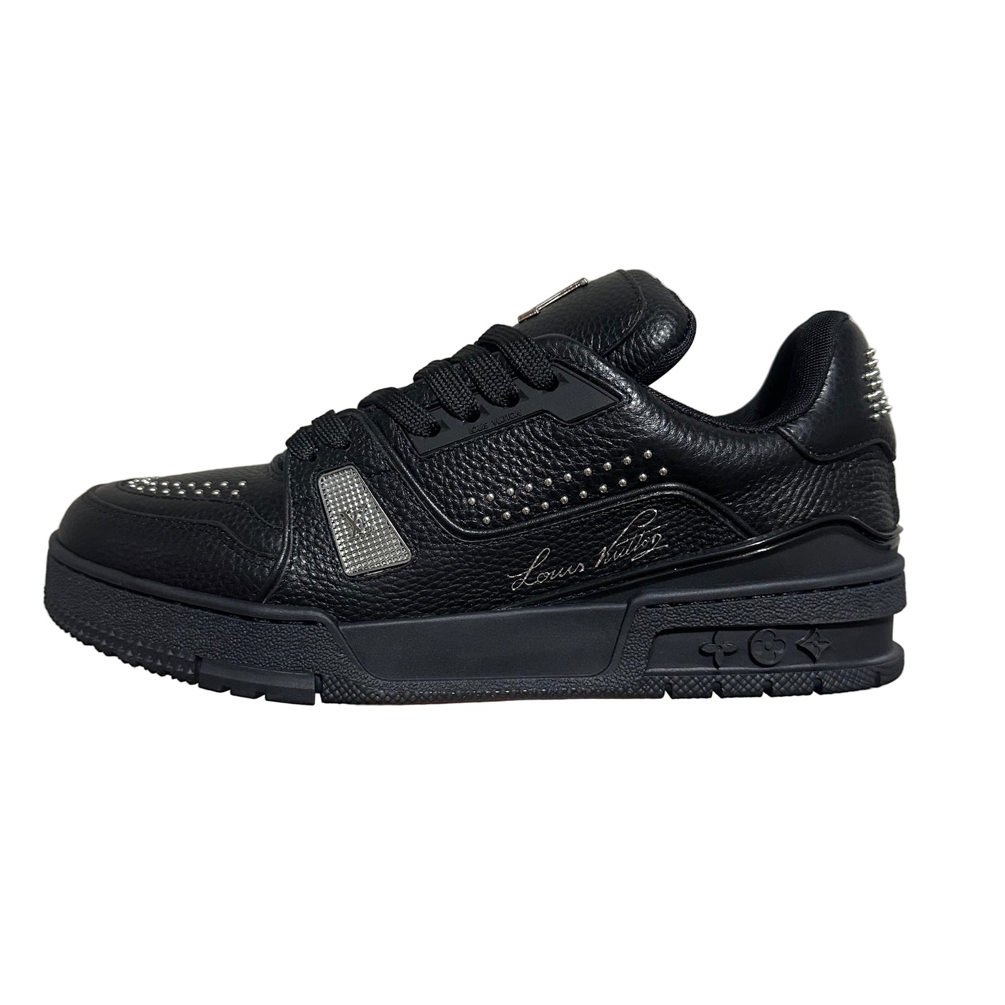 lv Black sneaker with studded details on a gray background