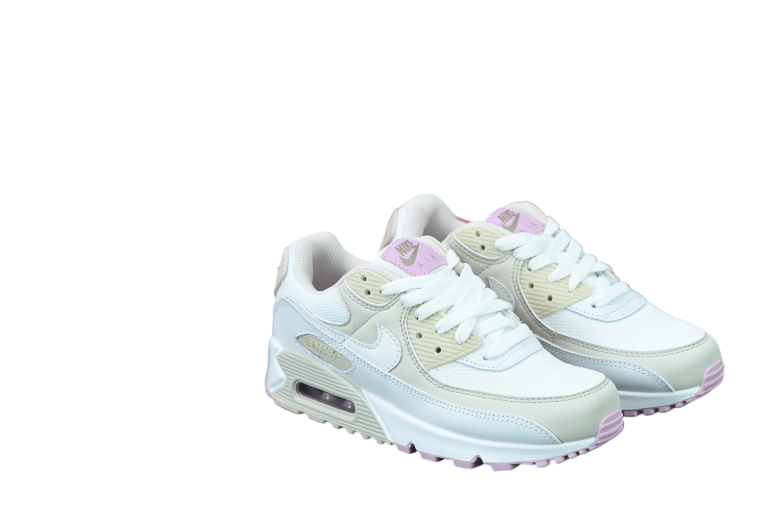 White sneakers with light pink accents on a white background