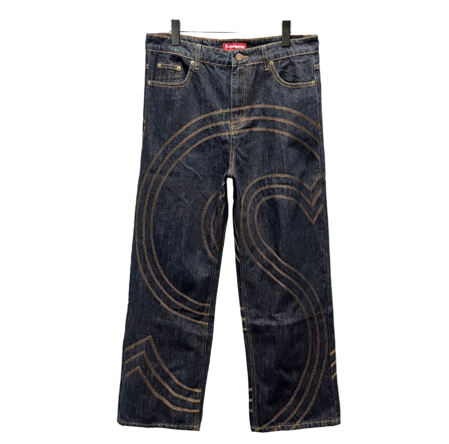 Pair of blue jeans with decorative stitching on a white background