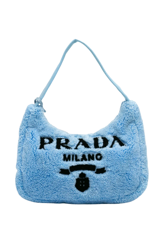Blue fluffy Prada handbag on a white background