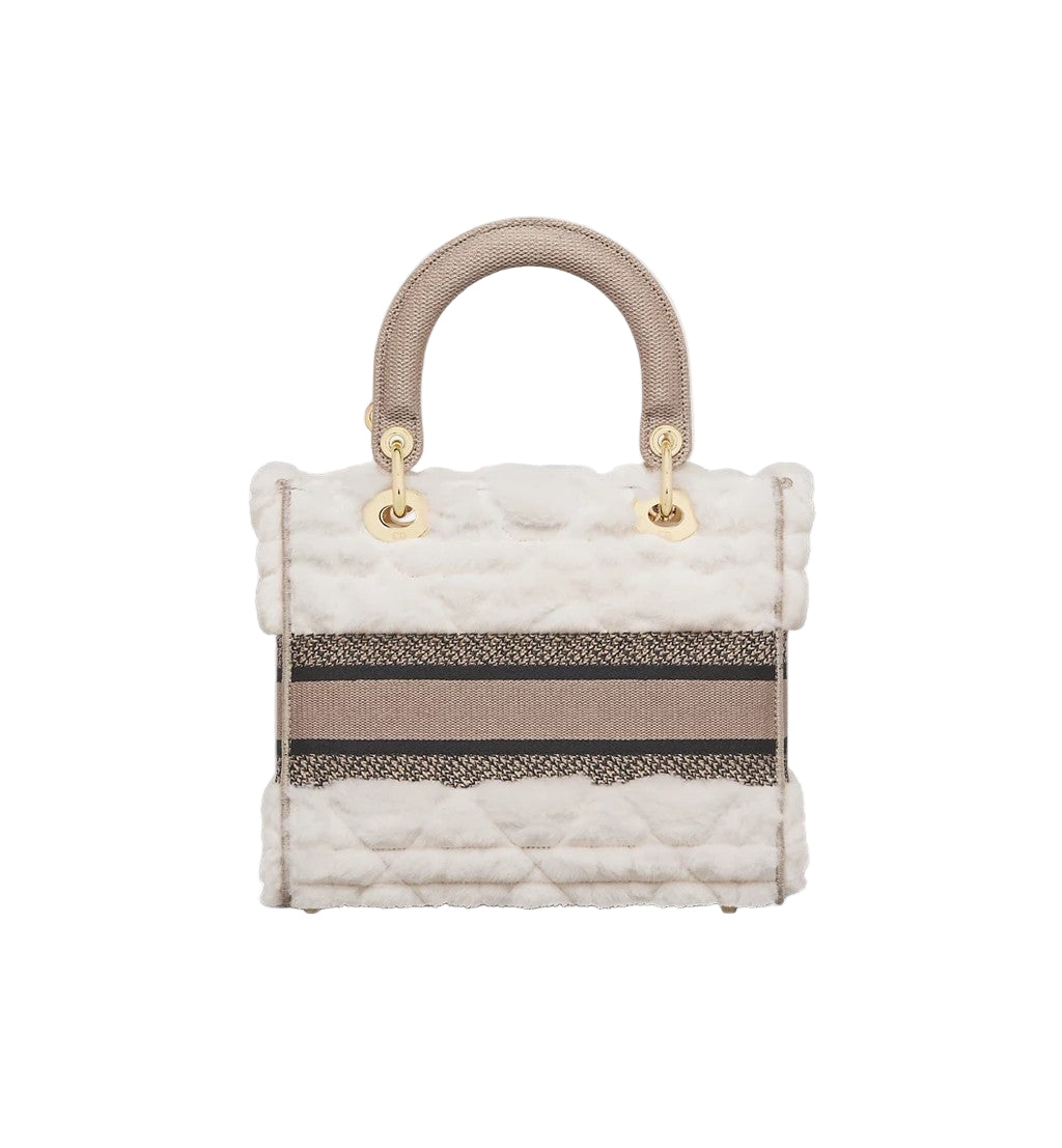 Quilted handbag with striped pattern on a white background