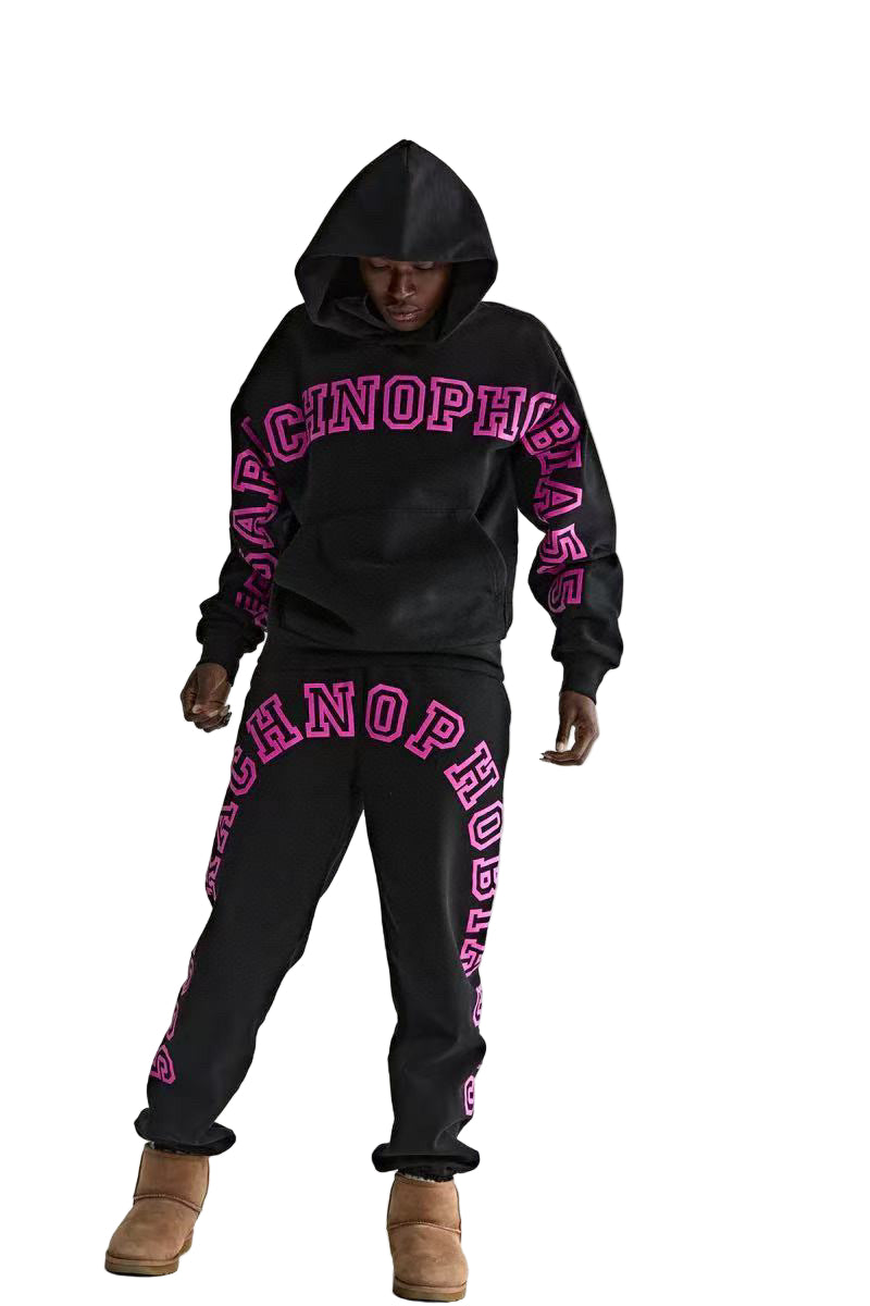 Person wearing a black hoodie and pants with pink text on a white background
