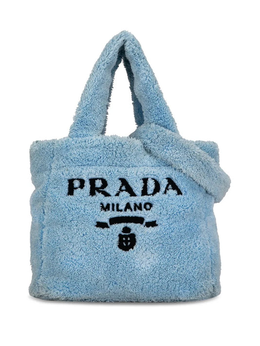 Blue fluffy Prada handbag on a white background