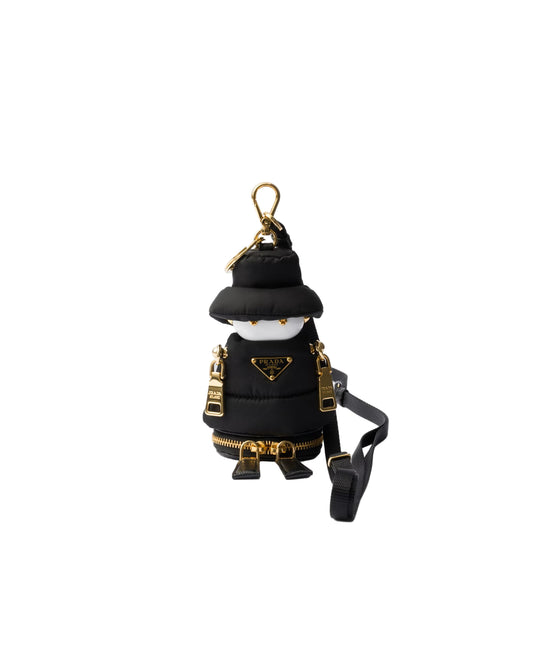 Black and gold keychain with a strap on a light gray background
