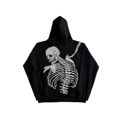 Black hoodie with a white skeleton design on a light gray background