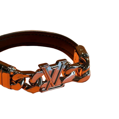 Silver chain bracelet with 'LV' logo on an orange background