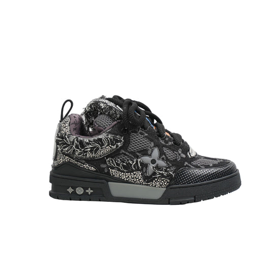 Black sneaker with floral patterns on a white background