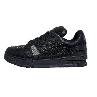 lv Black sneaker with studded details on a gray background