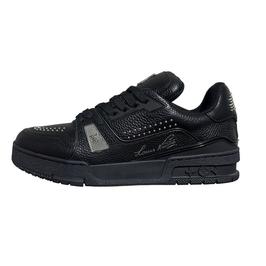 lv Black sneaker with studded details on a gray background