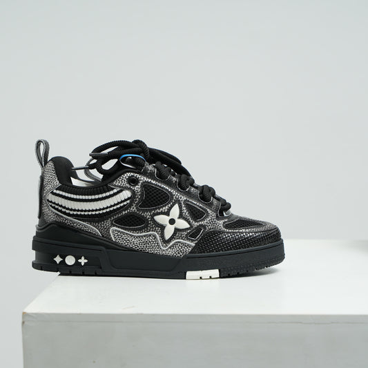 lv Black and gray sneaker with floral design on a white platform against a light gray background