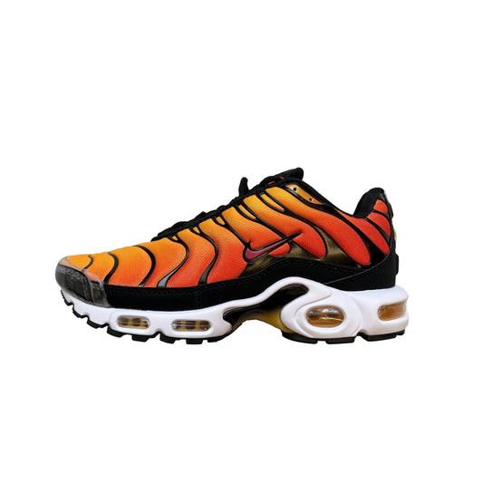 Orange and black sneaker with white sole on a gray textured background
