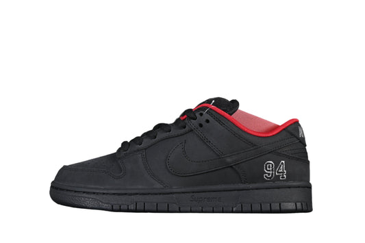 Black sneaker with red accents on a black background