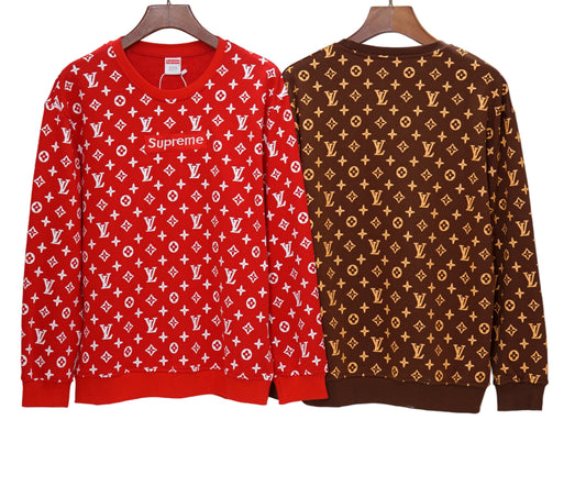 Red and brown patterned sweaters on hangers against a white background
