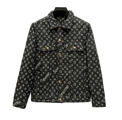Supreme x Louis Vuitton monogram denim jacket in black with all-over LV and Supreme logo pattern, displayed on a hanger against a white background.
